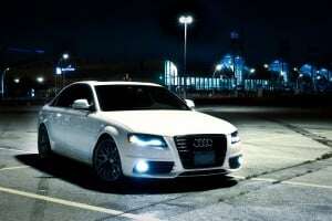 Image shows a white Audi A4 in a car park at night.