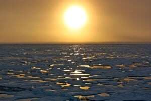 Image shows melting polar ice at sunset.