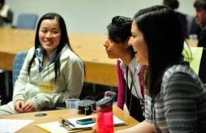 Image shows smiling job applicants at a recruitment event.