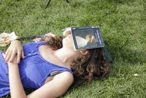 Image shows a young woman asleep with a copy of Northanger Abbey open over her face.
