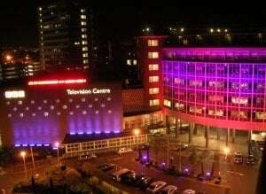 Image shows the BBC Television Centre lit up pink for the 2005 General Election.
