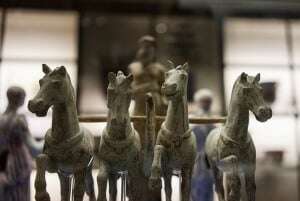 Image shows a statuette of a charioteer in the British Museum.