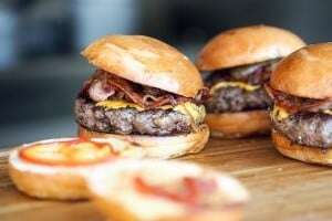 Image shows a plate of burgers.