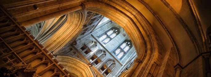 Image shows the interior of Canterbury Cathedral.