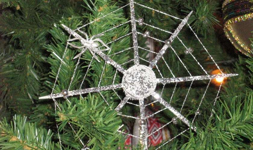 Image shows a cobweb Christmas tree decoration, complete with model spider.