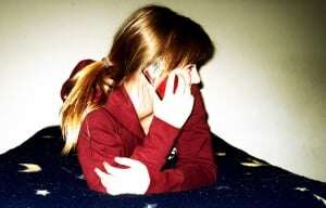 Image shows a woman talking on the phone.