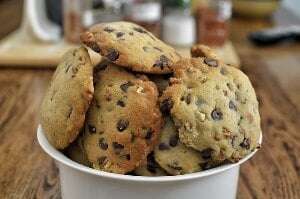 Image shows a bowl of choc-chip cookies.
