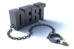 Image shows the word "debt" with a shackle attached to it.