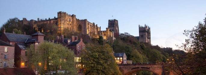 Image shows Durham Castle and Cathedral from the river.