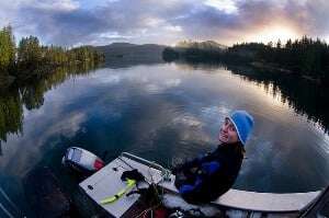 Image shows an ecologist on a lake. 