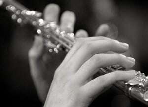 Image shows someone playing the flute.