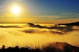 Image shows mountains in fog.