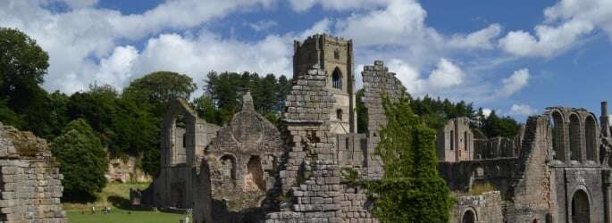 Image shows the ruins of Fountains Abbey.