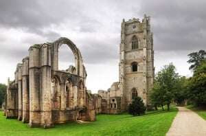 Image shows the dramatic ruins of Fountains Abbey.