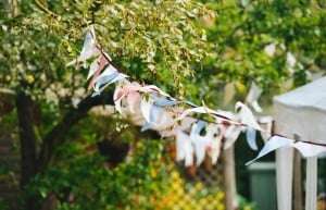 Image shows a garden party with bunting.