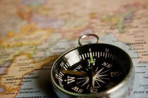 Image shows a compass on a map.