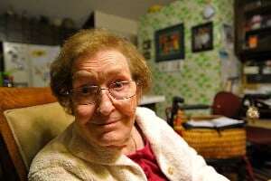 Image shows a grandmotherly woman smiling at the camera. 