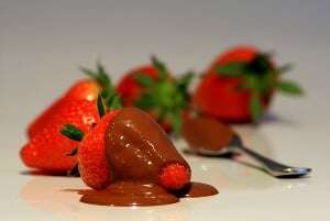 Image shows strawberries dipped in chocolate.