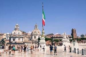 Image shows an Italian flag on a square in Rome. 