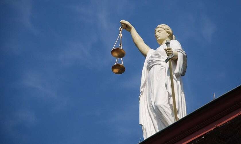 Image shows Lady Justice, holding the Scales of Justice.