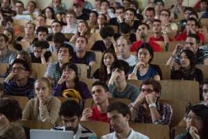 Image shows a bored-looking lecture audience.