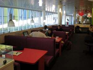 Image shows students working away in a library.