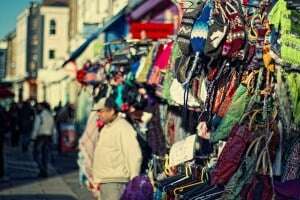 Image shows a stall selling knitwear at the Portobello Market.