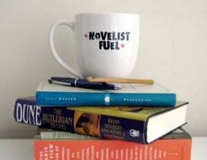 Image shows a stack of books on writing with a mug on top that reads "novelist fuel."