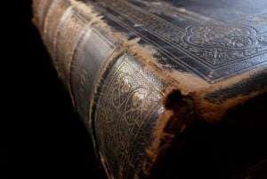 Image shows an old, worn book. 