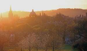 Image shows the city of Oxford, seen from South Park, at sunset.