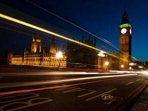Image shows the Houses of Parliament at night.