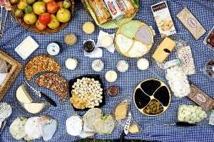 Image shows an array of picnic food spread out on a blanket.