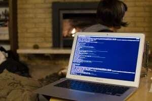Image shows a laptop that someone is coding on. 