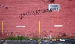 Image shows graffiti that says "who watches", but with a spelling mistake.