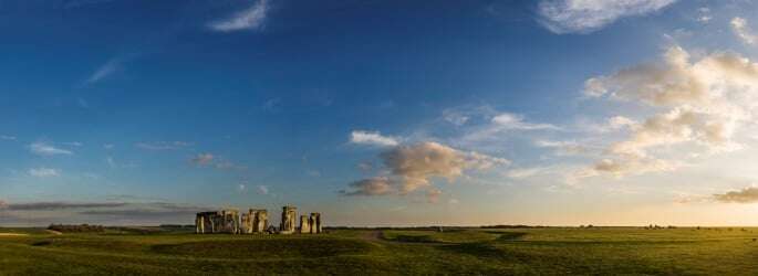 Image shows Stonehenge in the evening light.