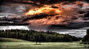 Image shows a storm over a forest.