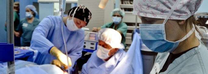 Image shows doctors performing surgery.