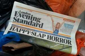 Image shows a tabloid newspaper in a bin.