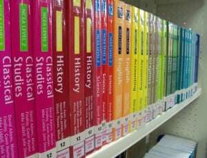 Image shows a row of textbooks with colourful spines.