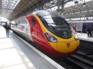 Image shows a Virgin Pendolino train in a station.