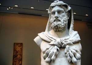 Image shows a statue of the Greek God Zeus. 