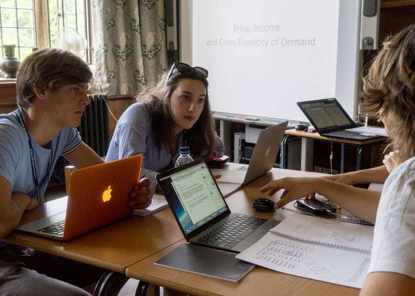 Three students discuss a complicated concept. 