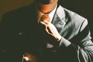 image shows a man in a suit and tie