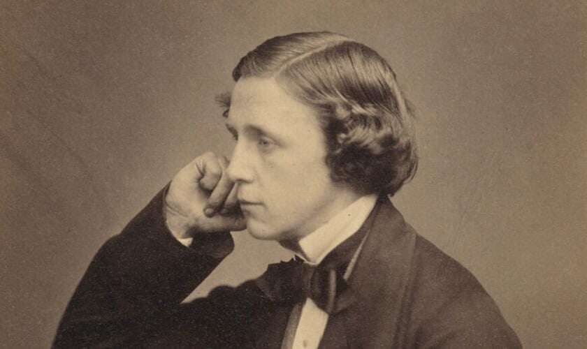 Image shows a black-and-white photo of Lewis Carroll.