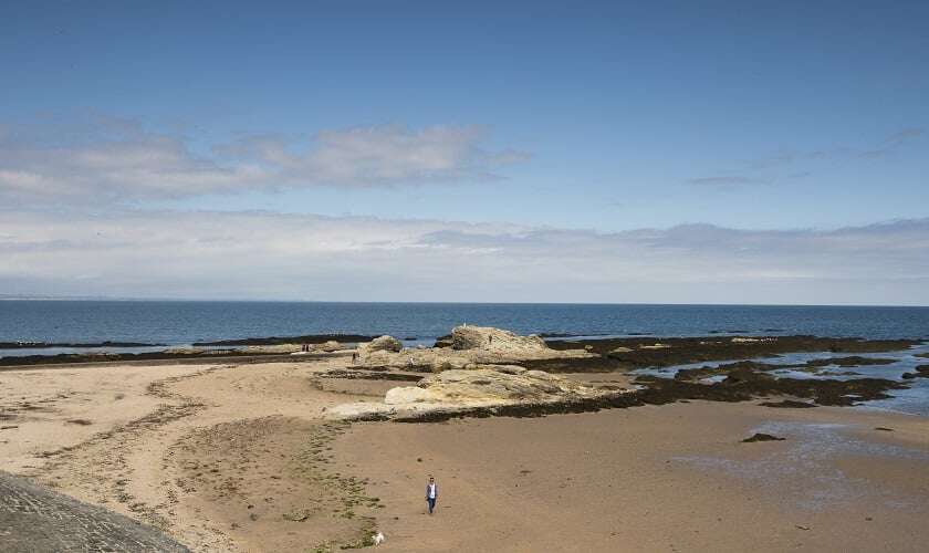 Image shows the beach by St Andrews on a sunny day.